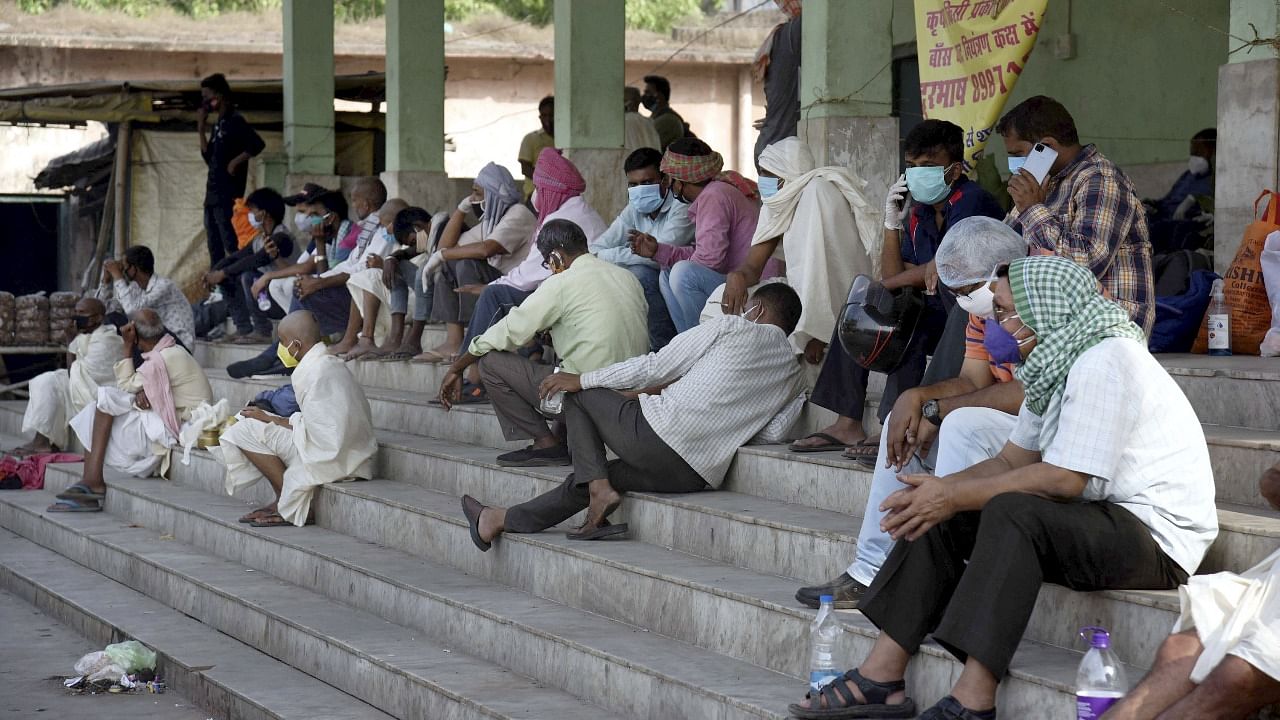 Relatives of Covid-19 victims wait for cremation at Bans Ghat electric crematorium, in Patna. Credit: PTI photo