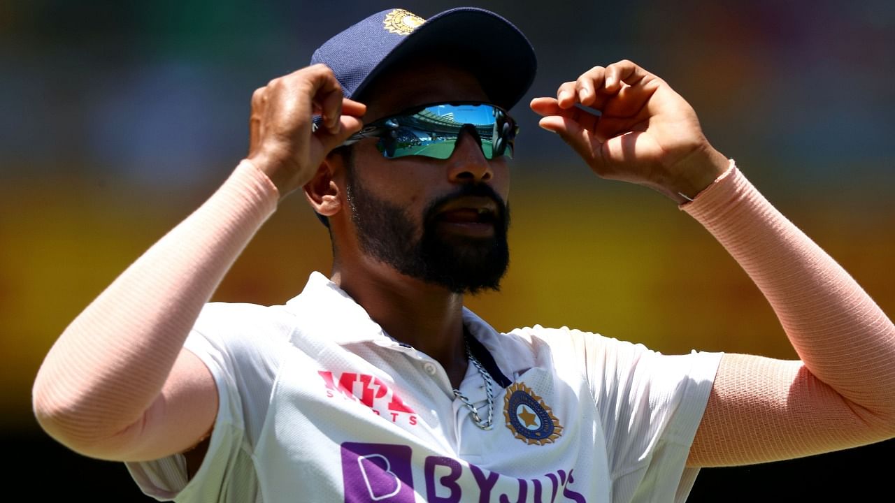 India's paceman Mohammed Siraj adjusts his glasses on day one of the fourth cricket Test match between Australia and India at the Gabba in Brisbane on January 15, 2021. Credit: AFP File Photo