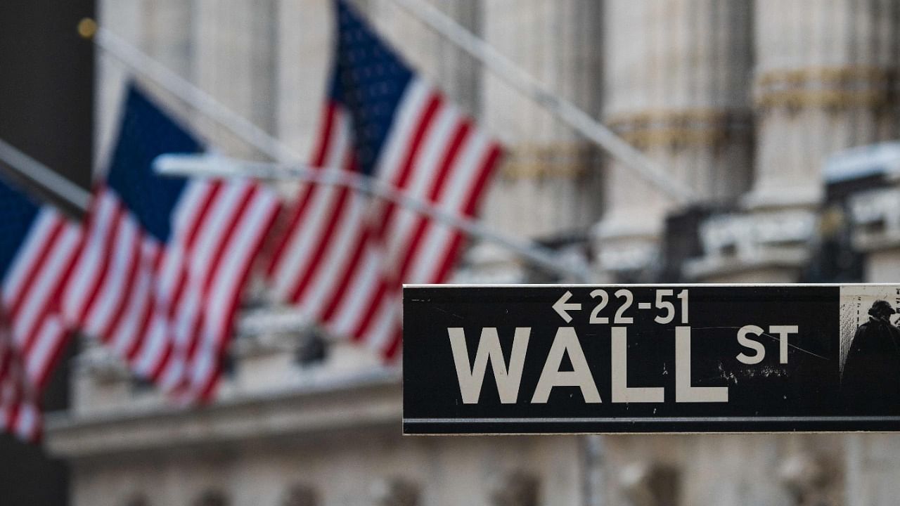 Wall St sign hangs at the New York Stock Exchange (NYSE) at Wall Street. Credit: AFP Photo