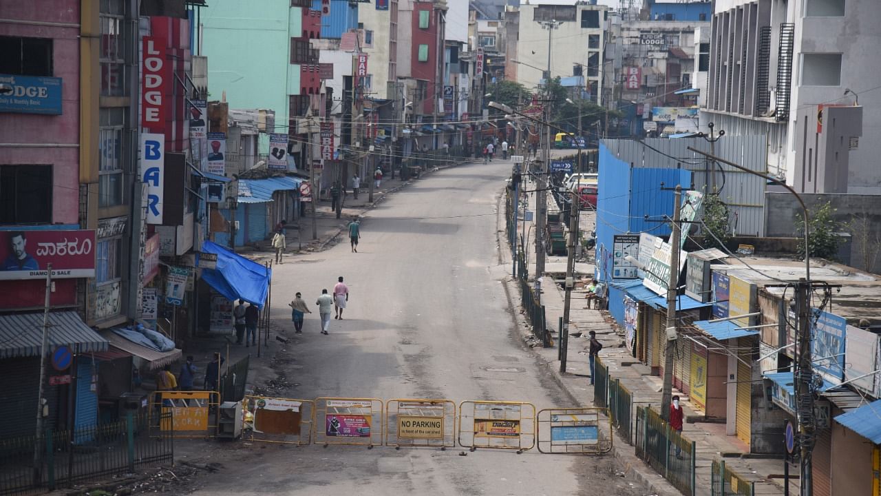 Kalasipalya main road is closed during the Covid-19 weekend curfew in Bengaluru. Credit: DH Photo/S K Dinesh