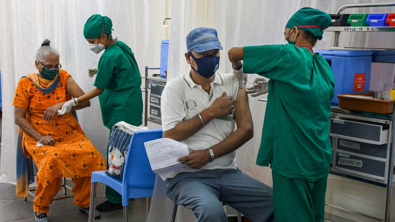 A BMC medical staff administers a dose of COVID-19 vaccine to a beneficiary at Nair hospital, in Mumbai. Credit: PTI photo.
