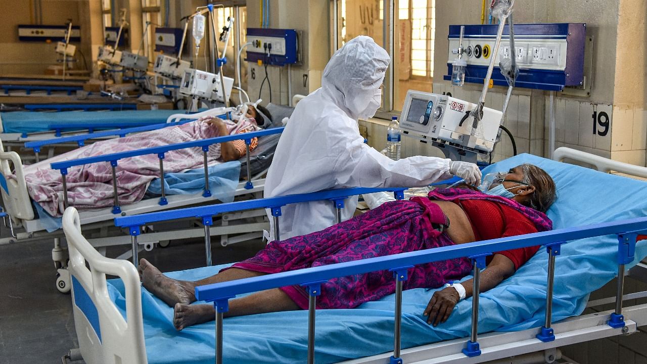 A health worker wearing PPE, attends to Covid-19 patients at a ICU Covid Ward with Oxygen and Ventilator facilities. Credit: PTI photo