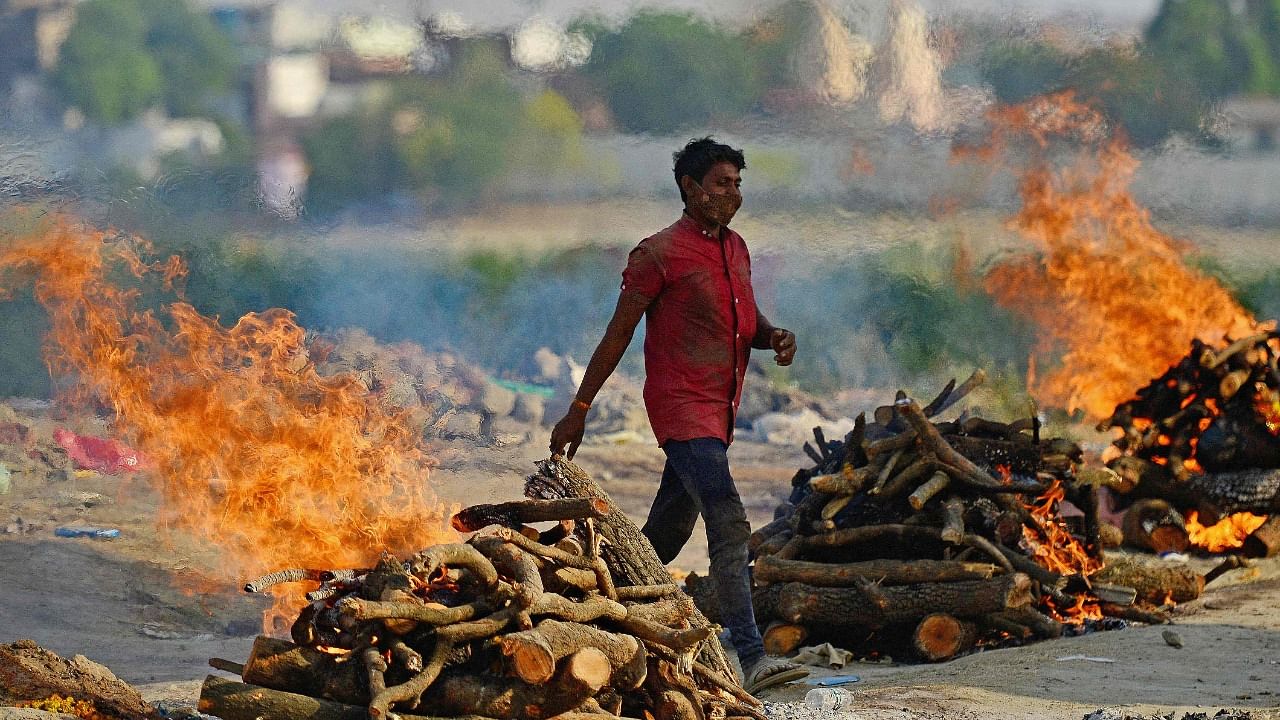 Funeral pyres burn as the last rites are performed of the patients who died of the Covid-19 coronavirus at a cremation ground in Allahabad on April 27, 2021. Credit: AFP Photo