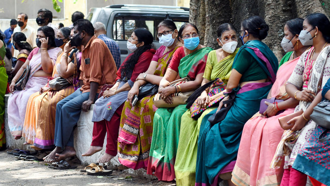 People wait to be vaccinated for COVID-19 at the General Hospital, as coronavirus cases surge across the country, in Thiruvananthapuram. Credit: PTI photo.