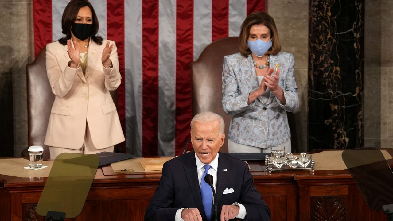 Harris, the first woman, Black and Asian person to serve as vice president, Pelosi, the first woman speaker of the House of Representatives sit behind Biden. Credit: Reuters Photo