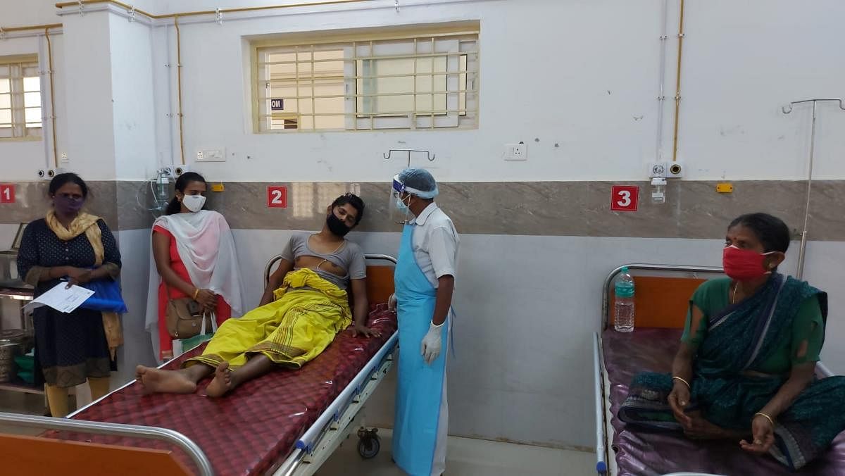 Priest Srikanth and his mother Shanthamma being treated at the district hospital, in Hassan.