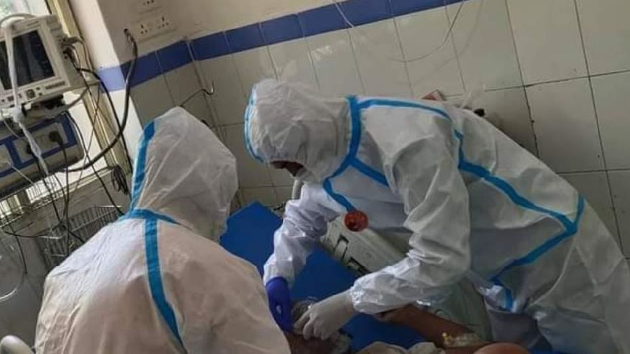ABVP members in PPE kits purportedly inside the Covid ward of Doon Medical College Hospital. Credit: Twitter Photo/@UttaranchalAbvp