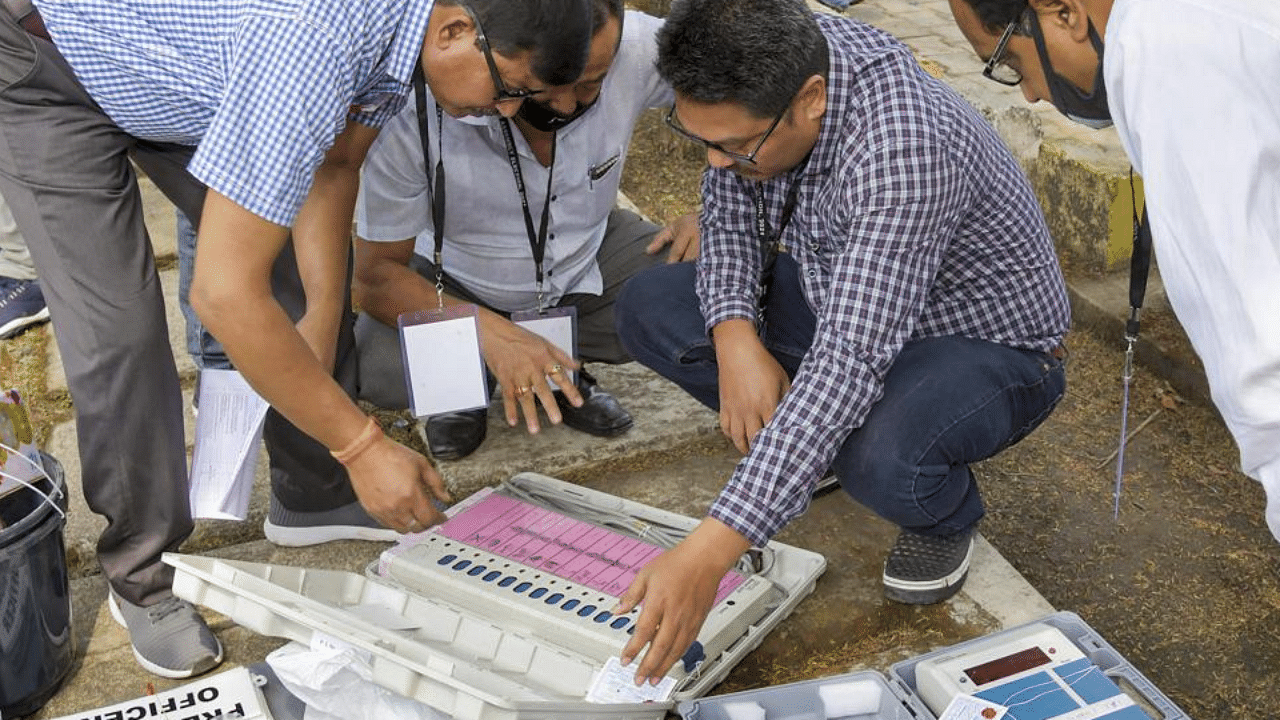 Polling officials check Electronic Voting Machines (EVMs) and other necessary inputs required for the Assembly elections, at a distribution centre, in Kamrup district, Monday, April 5, 2021. Credit: PTI Photo