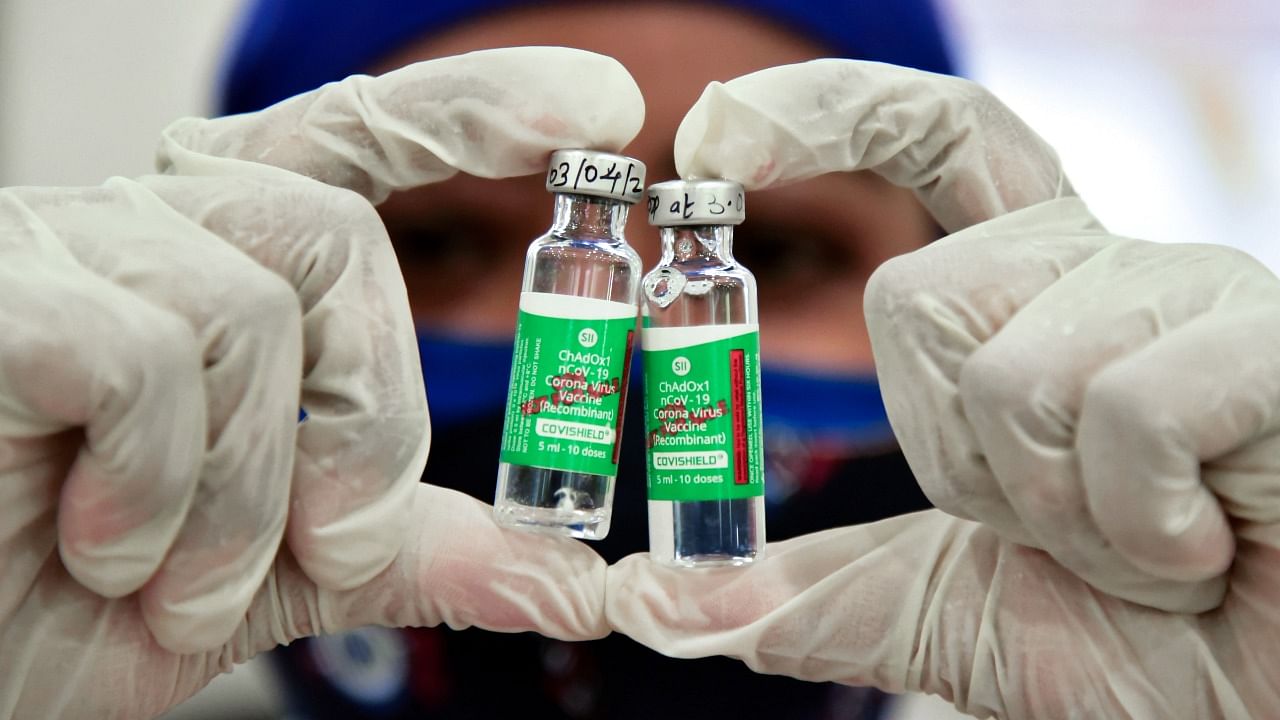 A medic shows the doses of Covid-19 vaccine during an inoculation drive, at a vaccination camp in Nagpur. Credit: PTI File Photo