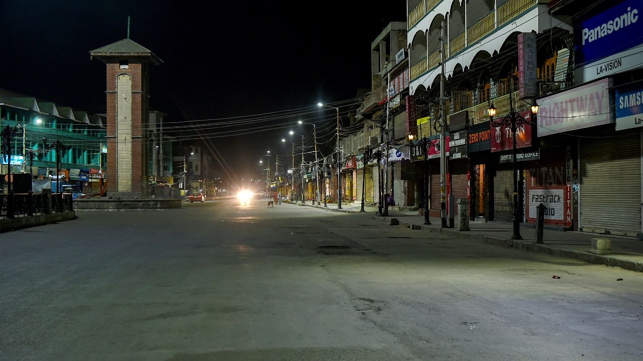 Srinagar's Lal Chowk area wears a deserted look during 84-hour lockdown imposed in 11 out of the 20 districts of J&K by administration in a bid to tackle the surge in Covid-19 cases. Credit: PTI Photo