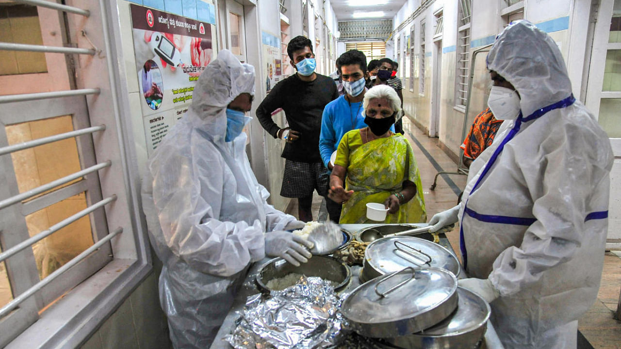 Health workers serve food to Covid-19 patients, during the second wave of the coronavirus pandemic in Bengaluru. Credit: PTI Photo