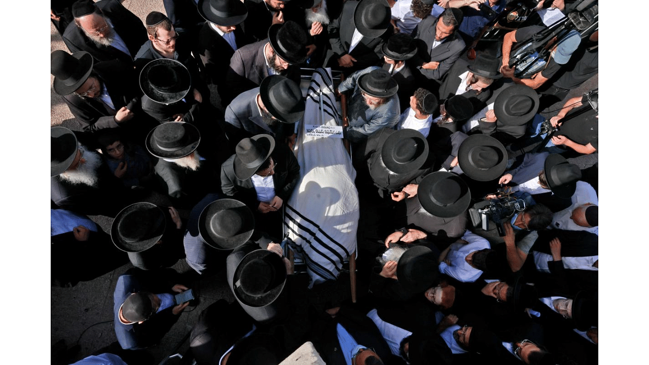 Ultra-Orthodox Jewish men take part in a funeral ceremony in Jerusalem for a victim of an overnight stampede during a religious gathering in northern Israel, on April 30, 2021. - A massive stampede at a densely packed Jewish pilgrimage site killed at least 44 people in Israel, blackening the country's largest COVID-era gathering. Credit: AFP Photo