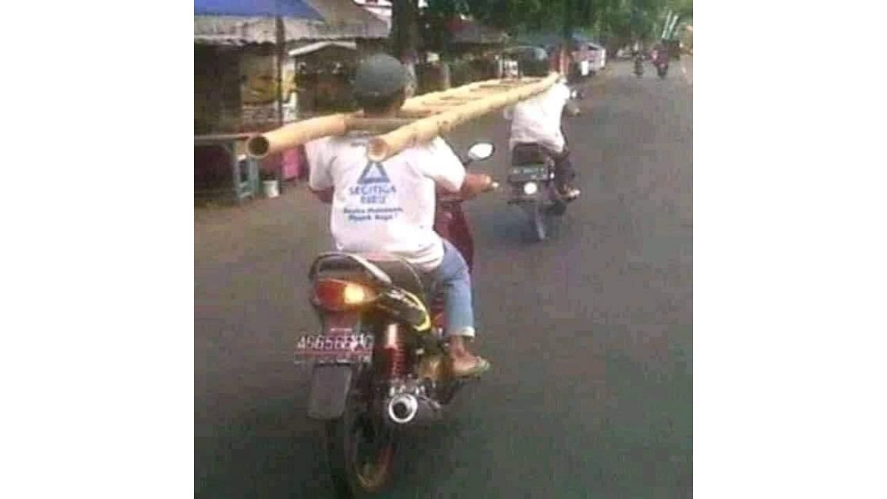 Social distancing method adopted by two bikers who were transporting a ladder. Credit: Twitter/@anandmahindra