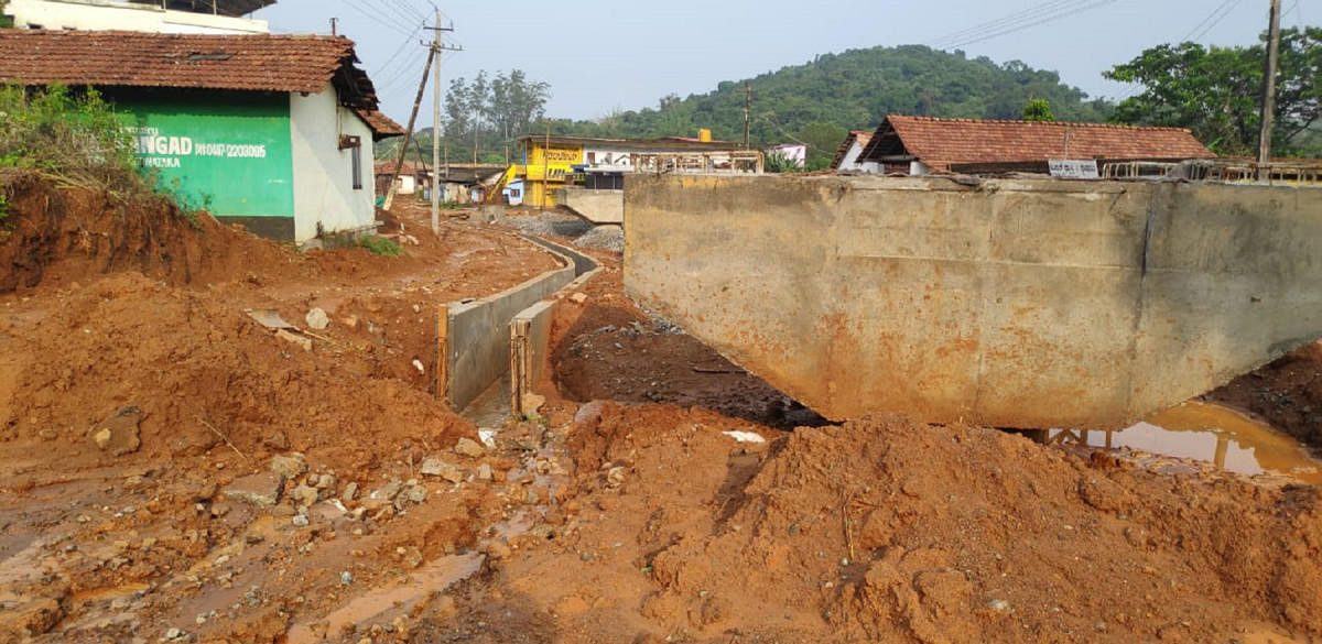 The soil from the flyover worksite has entered the road in Bhagamandala.