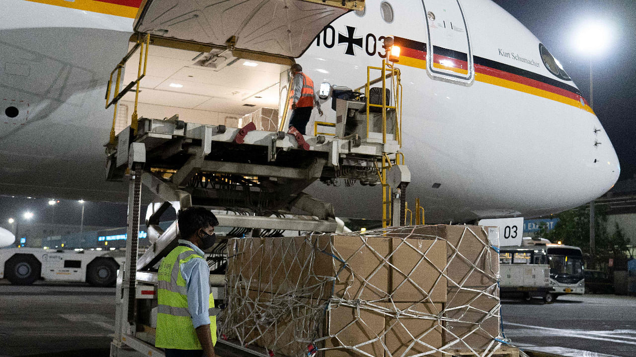 Ground staff unloading the Covid-19 coronavirus medical aid supplies from Germany, at an airport in New Delhi. Credit: AFP Photo