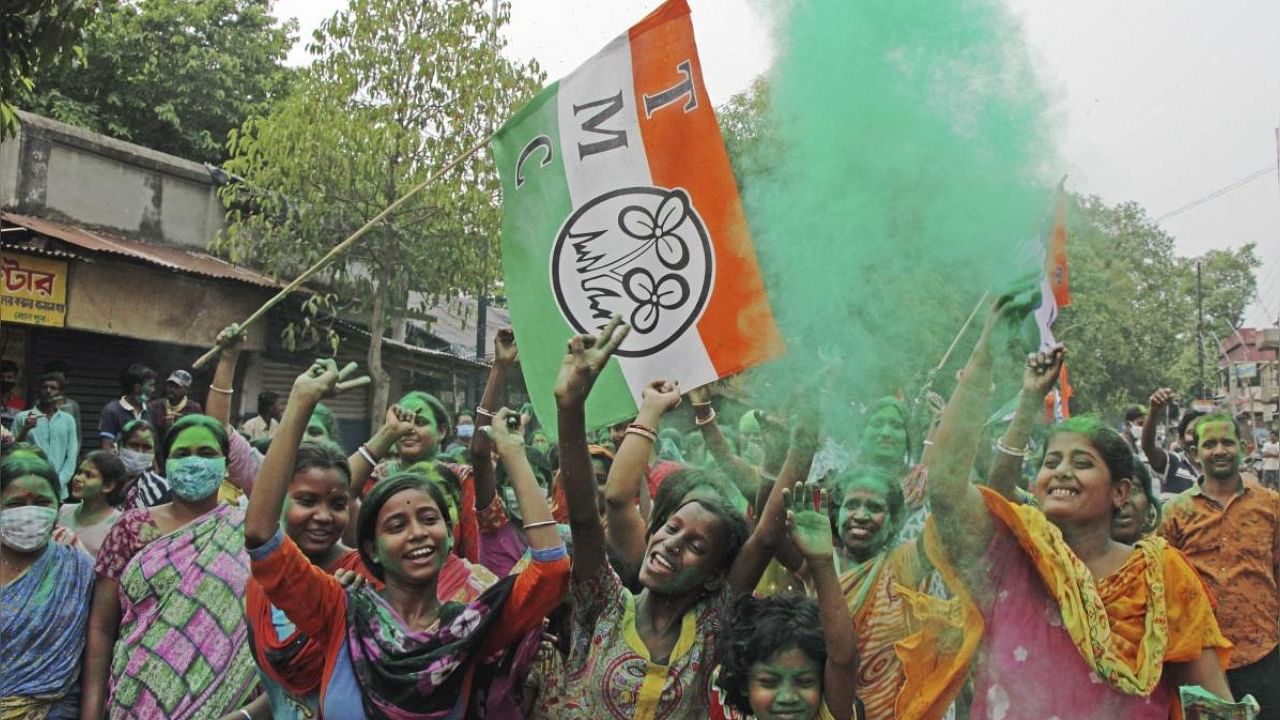 TMC supporters celebrate winning trend in the West Bengal state assembly elections at Bolpur in the Birbhum district of West Bengal. Credit: PTI Photo