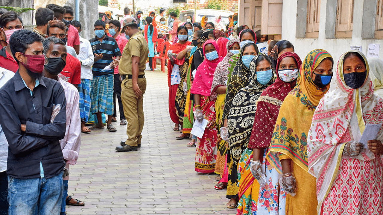 People stand in a queue to cast their votes during 8th and last phase of West Bengal Assembly Polls, in Murshidabad district of West Bengal, Thursday, April 29, 2021.  Credit: PTI Photo