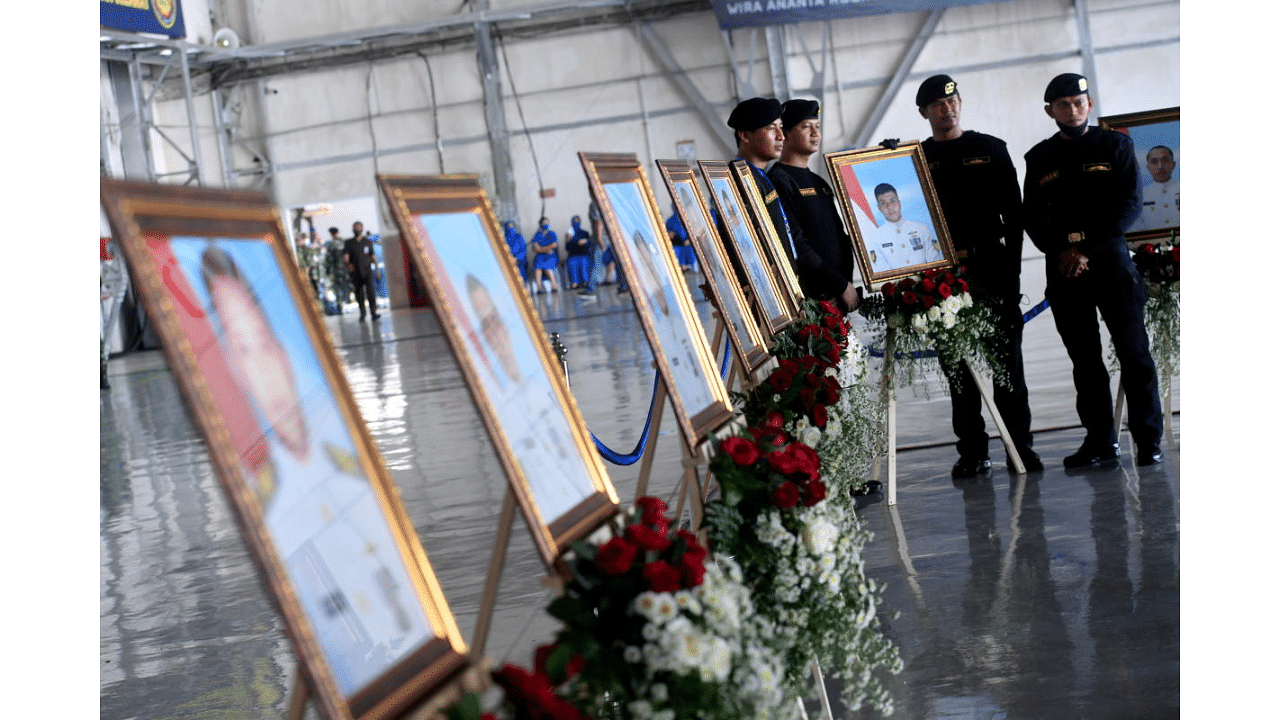 Indonesian Navy personnel stand near the portraits of the sunken KRI Nanggala-402 submarine crew members during a posthumous promotion ceremony at a navy airbase in Sidoarjo, East Java Province, Indonesia April 29, 2021.   Credit: Reuters Photo