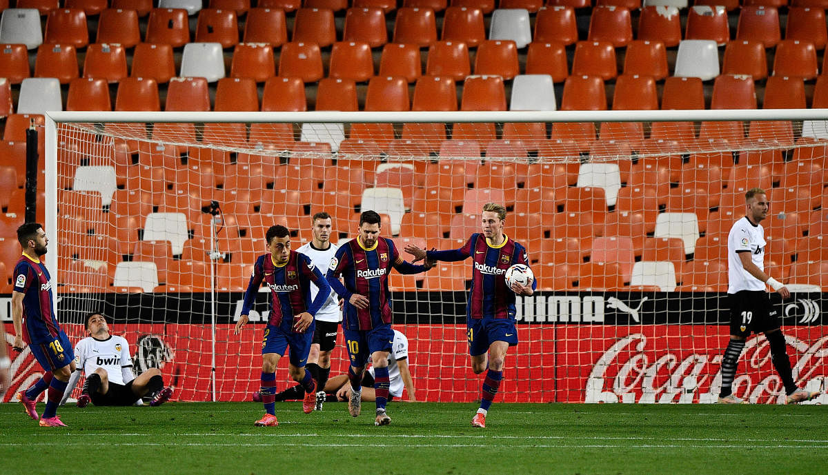 Barcelona's Lionel Messi (C) celebrates scoring their first goal with teammates. Credit: Reuters photo.