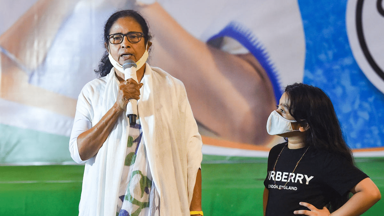 TMC supremo and West Bengal Chief Minister Mamata Banerjee with her nephew Abhisekh Banerjee's daughter Azania (R), during interaction with media after her party's victory. Credit: PTI Photo