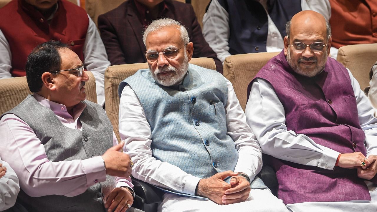 BJP National President J P Nadda (L), Prime Minister Narendra Modi (C), and Home Minister Amit Shah. Credit: PTI File Photo