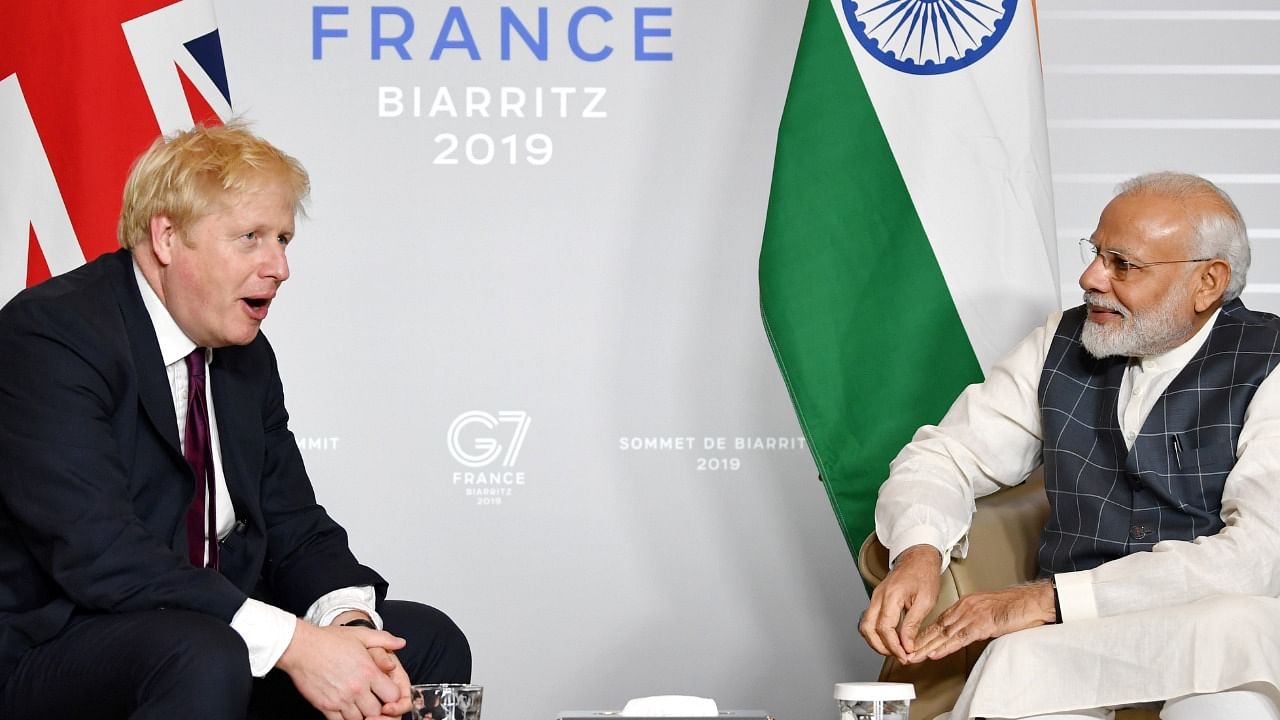 File photo of Britain's Prime Minister Boris Johnson and Indian Prime Minister Narendra Modi in Biarritz, France August 25, 2019. Credit: Reuters Photo