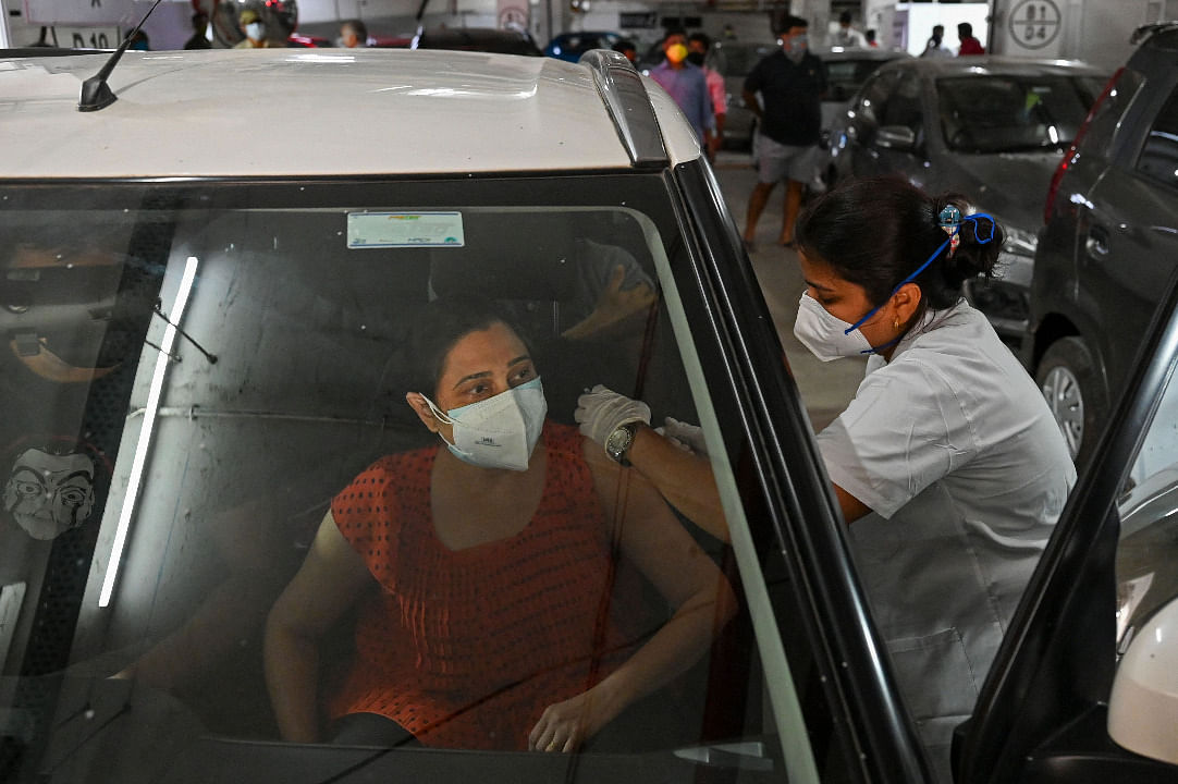 A woman gets inoculated at a drive-in vaccination facility in Mumbai on May 4.  Credit: AFP Photo