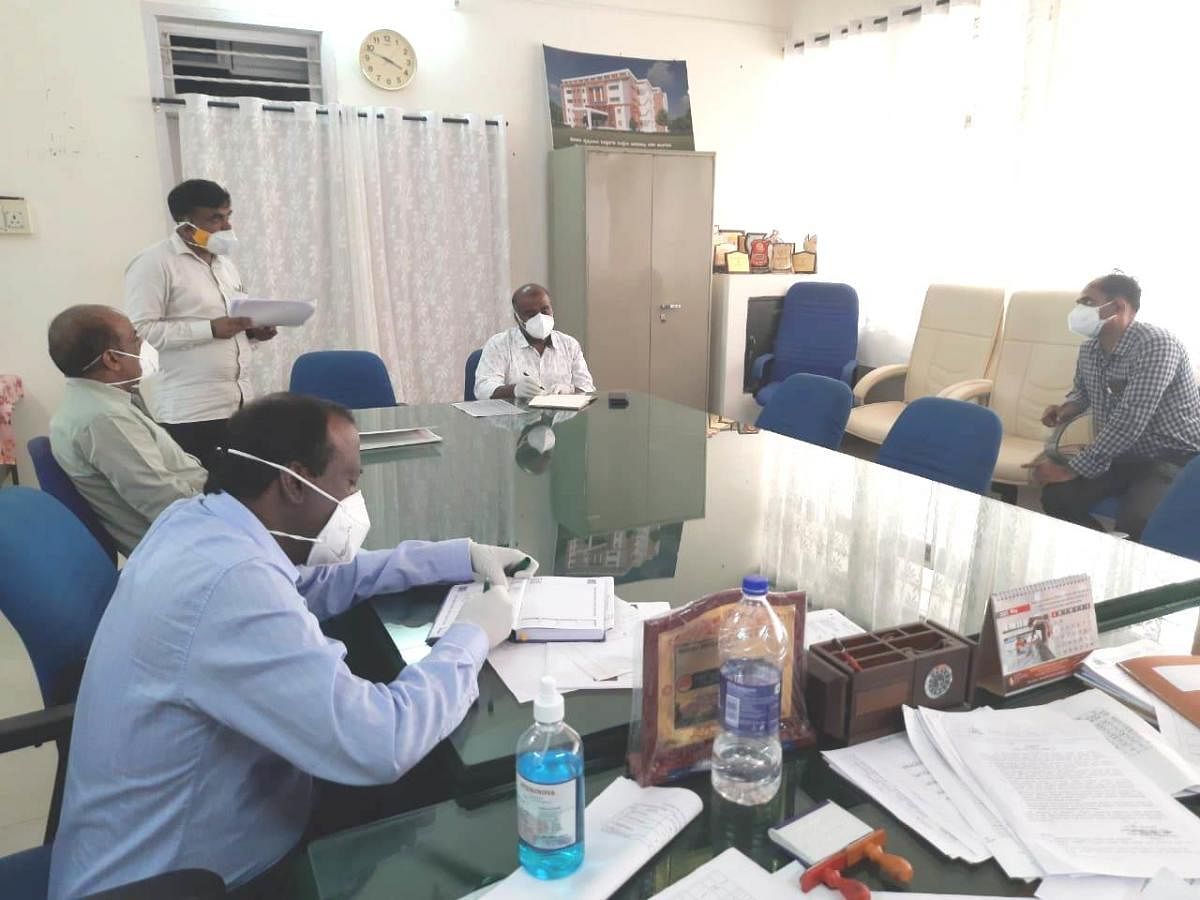 District In-charge Secretary V Anbu Kumar chairs a meeting in Madikeri on Wednesday.