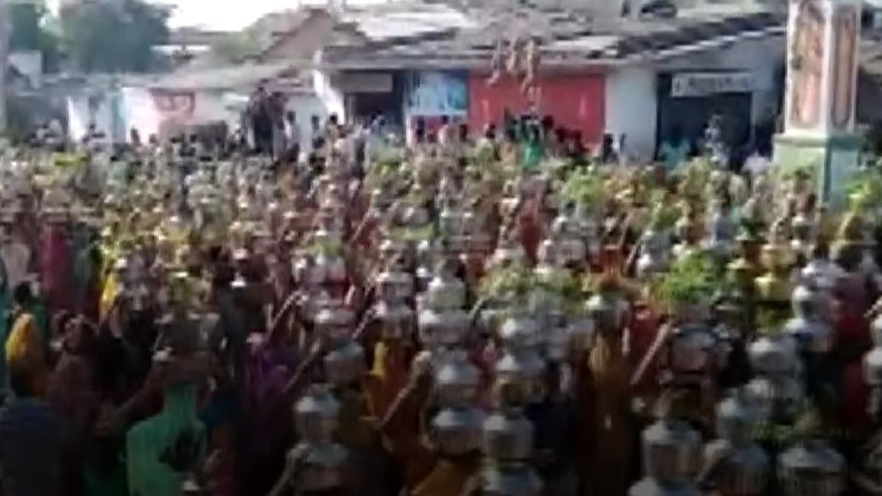 A video of the incident, which occurred in Navapura village in Sanand taluka on May 3, showed around 500 women carrying water pots on their heads while walking towards a temple. Credit: Screengrab via ANI