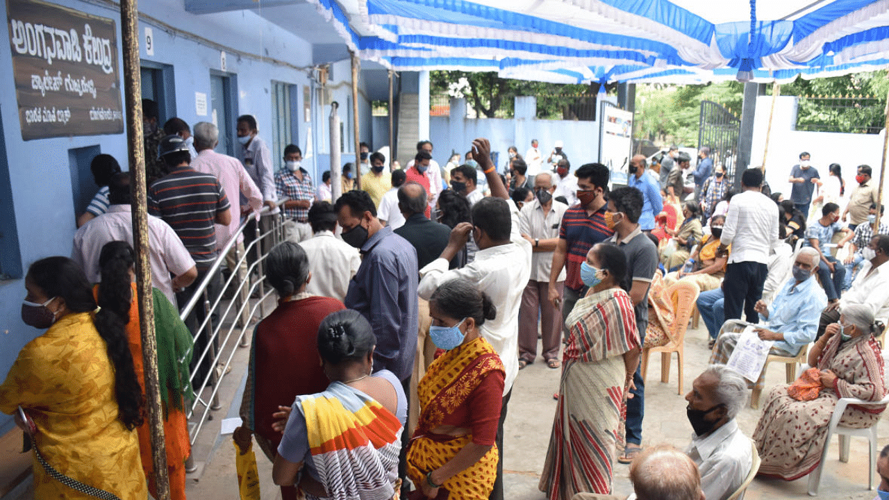 People wait to get vaccinated in Palace Guttahalli in Bengaluru on Thursday. Credit: DH Photo/Janardhan B K