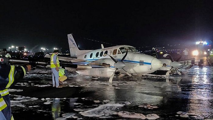 Emergency personnel work near a non-scheduled Beechcraft VT-JIL aircraft en-route from Nagpur to Hyderabad after an emergency belly-landing at the CSMIA, in Mumbai. Credit: AFP Photo