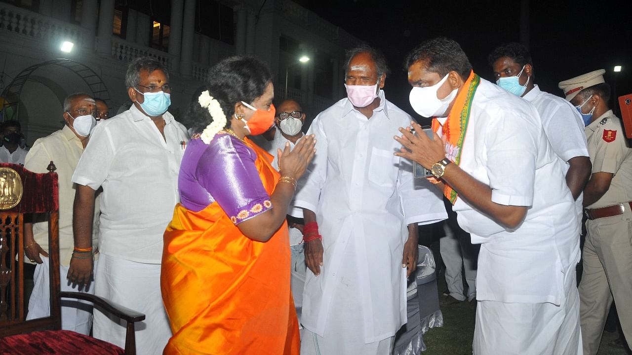 Deputy Governor Tamilisai Soundarajan greets the winners' NR Congress leader N.Rangasamy and BJP candidate Namatchivayam for the victory of their alliance in the election, in Puducherry. Credit: PTI Photo