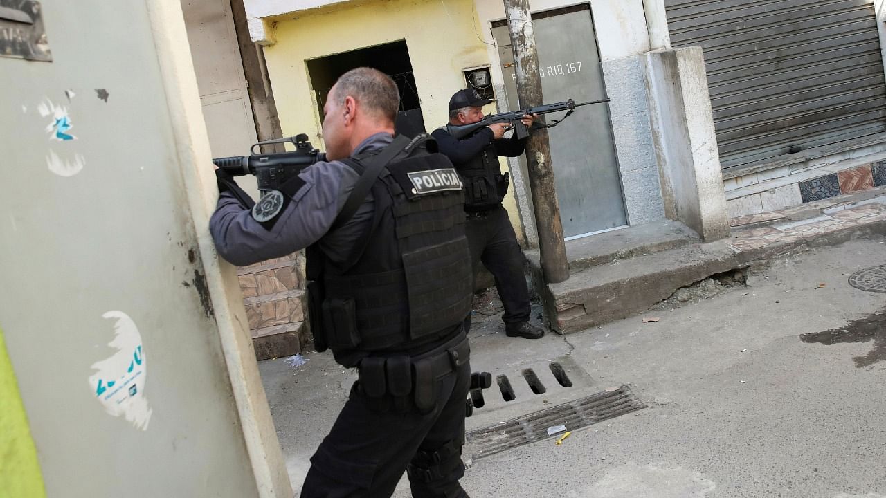 Policemen aim their weapons during an operation against drug dealers in Jacarezinho slum in Rio de Janeiro, Brazil May 6, 2021. Credit: Reuters File Photo