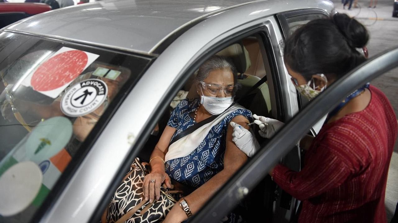 A senior citizen receives Covid-19 vaccine shot during a drive-in vaccination, in Mumbai. Credit: PTI Photo
