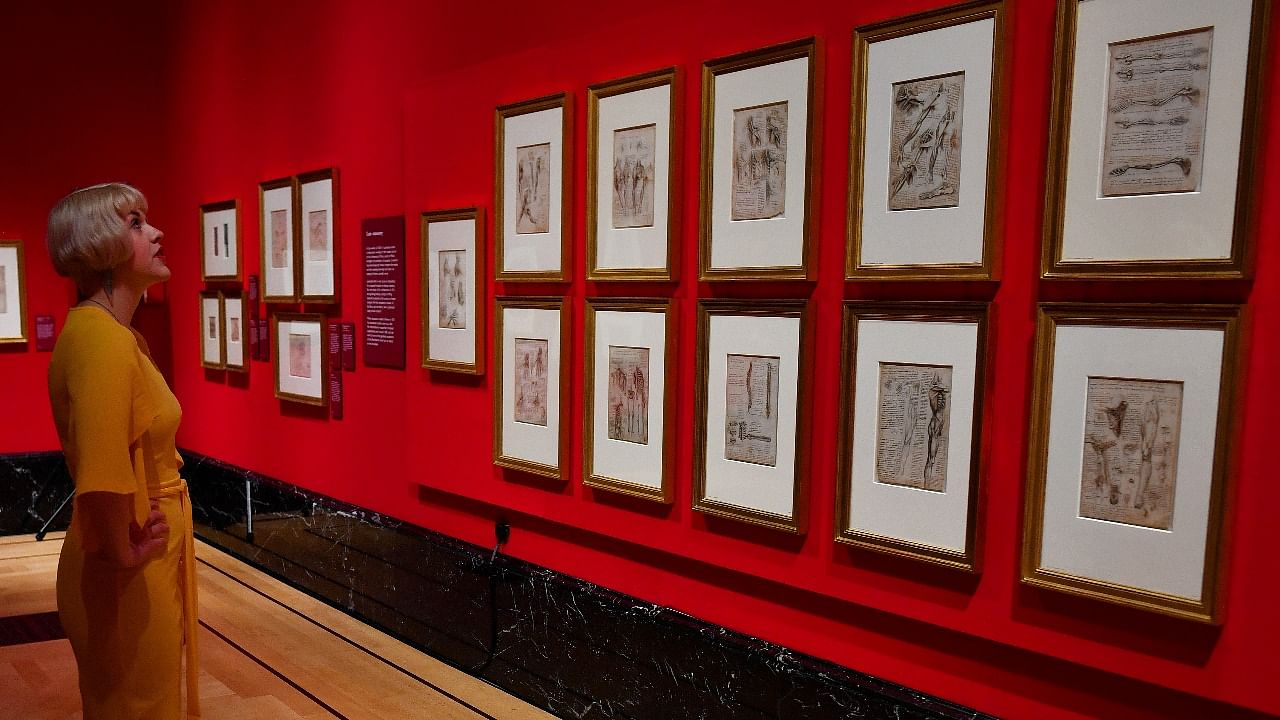 Royal Collection Trust staff pose beside some of Leonardo Da Vinci's anatomical studies at A Life in Drawing in London. Credit: Reuters photo