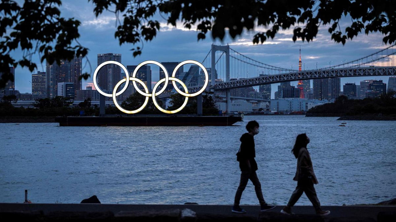 Olympic rings lit up at dusk on the Odaiba waterfront in Tokyo. Credit: AFP Photo