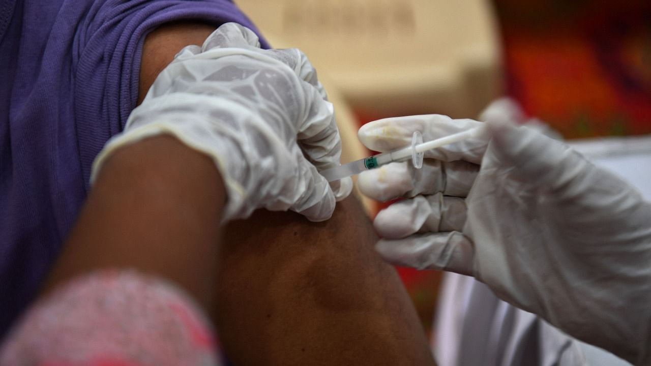 A medical worker inoculates a man with a dose of the Covaxin vaccine against the Covid-19 coronavirus at a vaccination centre in Mumbai on May 9, 2021. Credit: AFP Photo