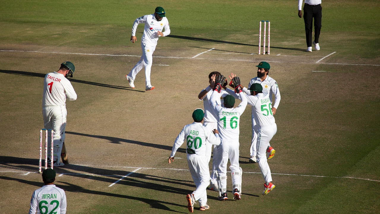 Pakistan players celebrate the wicket of Zimbabwean captain Brendan Taylor, left, during the second test cricket match against Zimabwe at Harare Sports Club. Credit: AP Photo