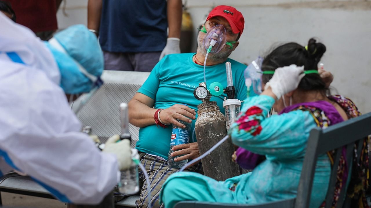 Patients on oxygen support, wait outside the Covid-19 facility of the Chest Disease Hospital in Jammu, Sunday, May 9, 2021. Credit: PTI Photo