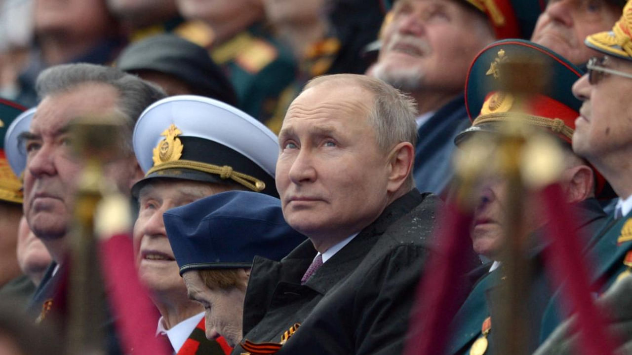Russian President Vladimir Putin watches the Victory Day military parade at Red Square in Moscow on May 9, 2021. Credit: AFP Photo