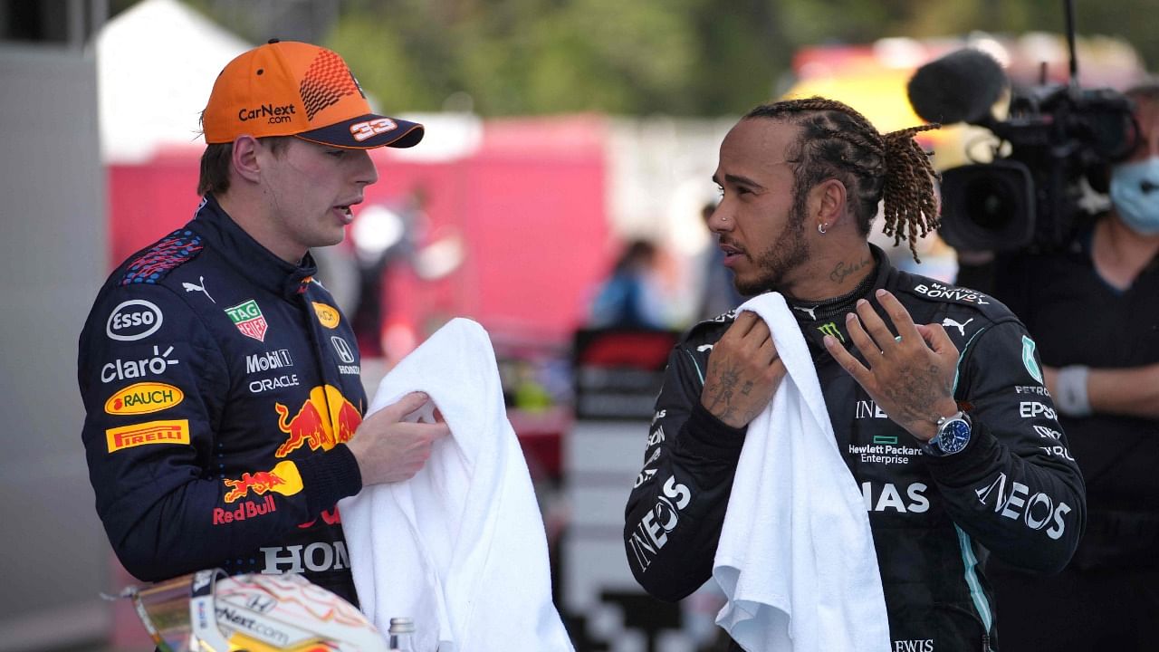 Mercedes' British driver Lewis Hamilton talks to Red Bull's Dutch driver Max Verstappen after the Spanish Grand Prix race. Credit: AFP Photo