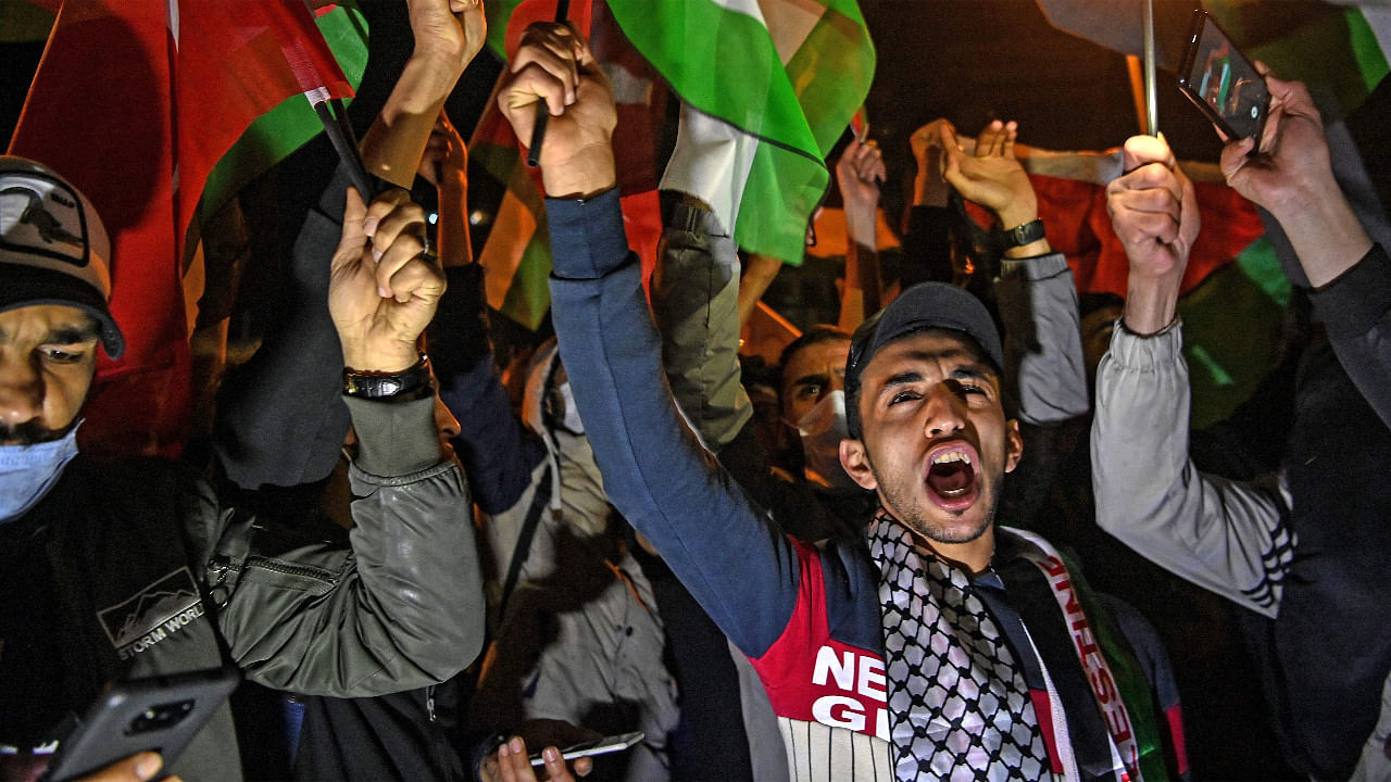 Protesters hold Palestine and Turkish national flags and chant slogans during a demonstration against Israel in front of the Israeli Consulate in Istanbul. Credit: AFP Photo