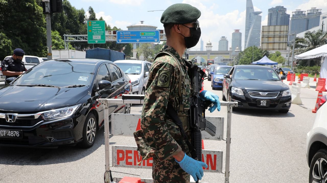 A soldier stands guard at a roadblock during lockdown ahead of the Eid al-Fitr celebrations in an effort to prevent a large-scale transmission of coronavirus, in Petaling Jaya, Malaysia May 10, 2021. Credit: Reuters Photo