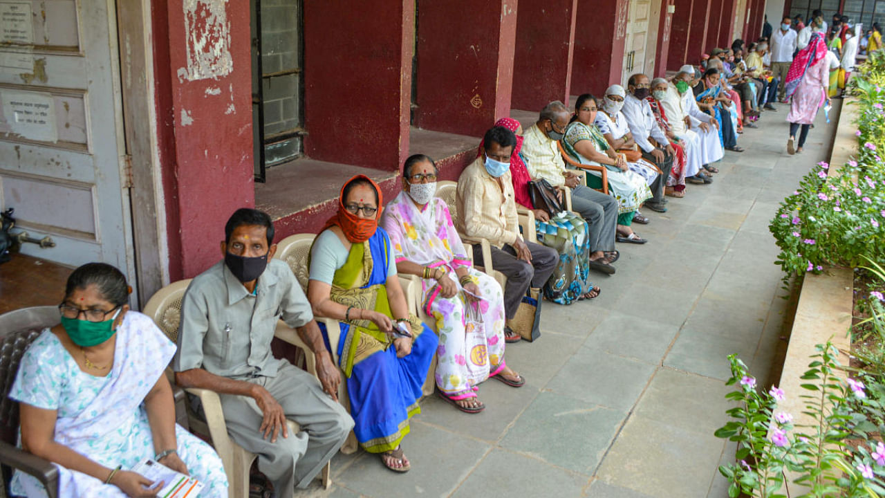 Beneficiaries above 45 years of age, wait for the dose of Covid-19 vaccine at KMC vaccination centre in Karad, Maharashtra. Credit: PTI Photo