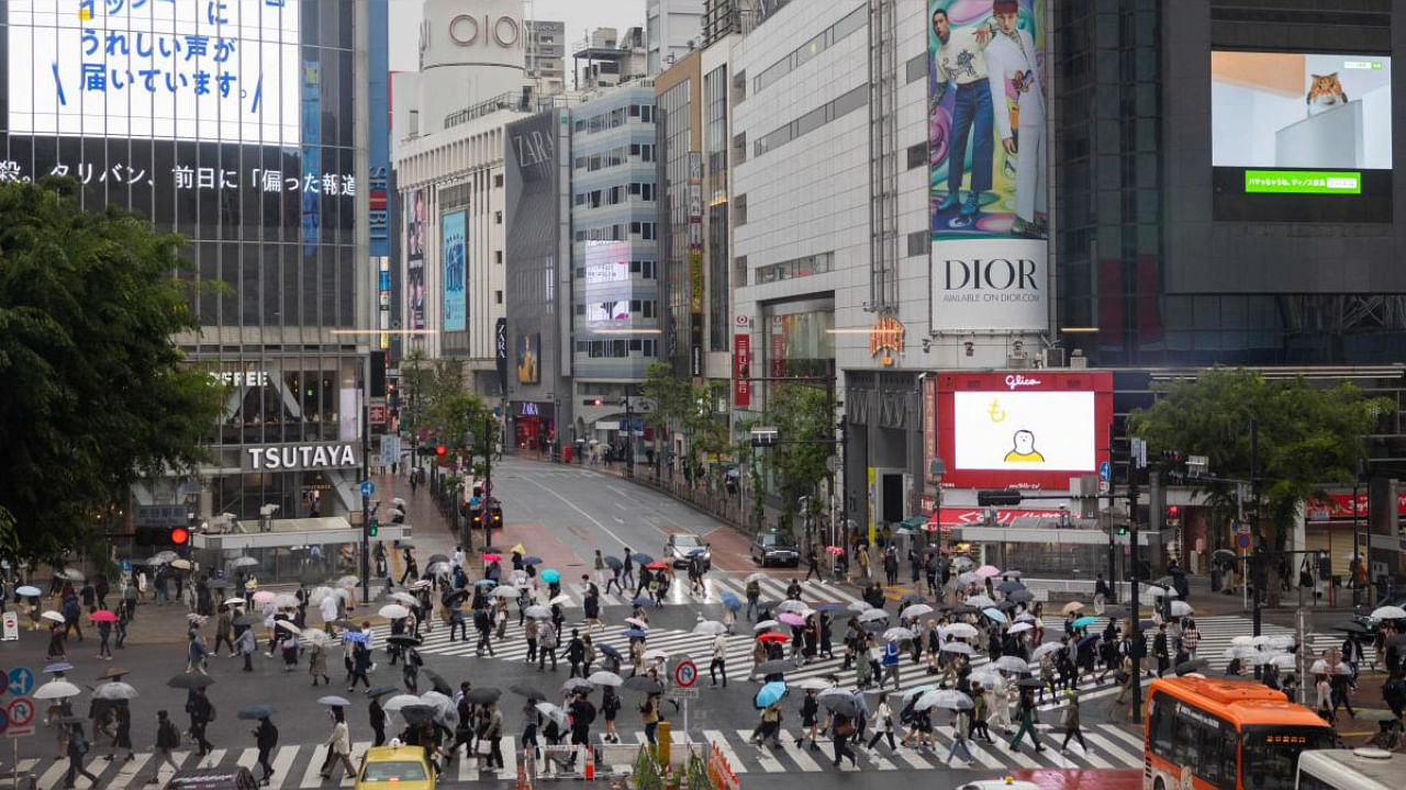 People walk on Shibuya crossing in Tokyo on May 7, 2021, during a coronavirus state of emergency covering Tokyo, Osaka, Kyoto and Hyogo regions. Credit: AFP File Photo