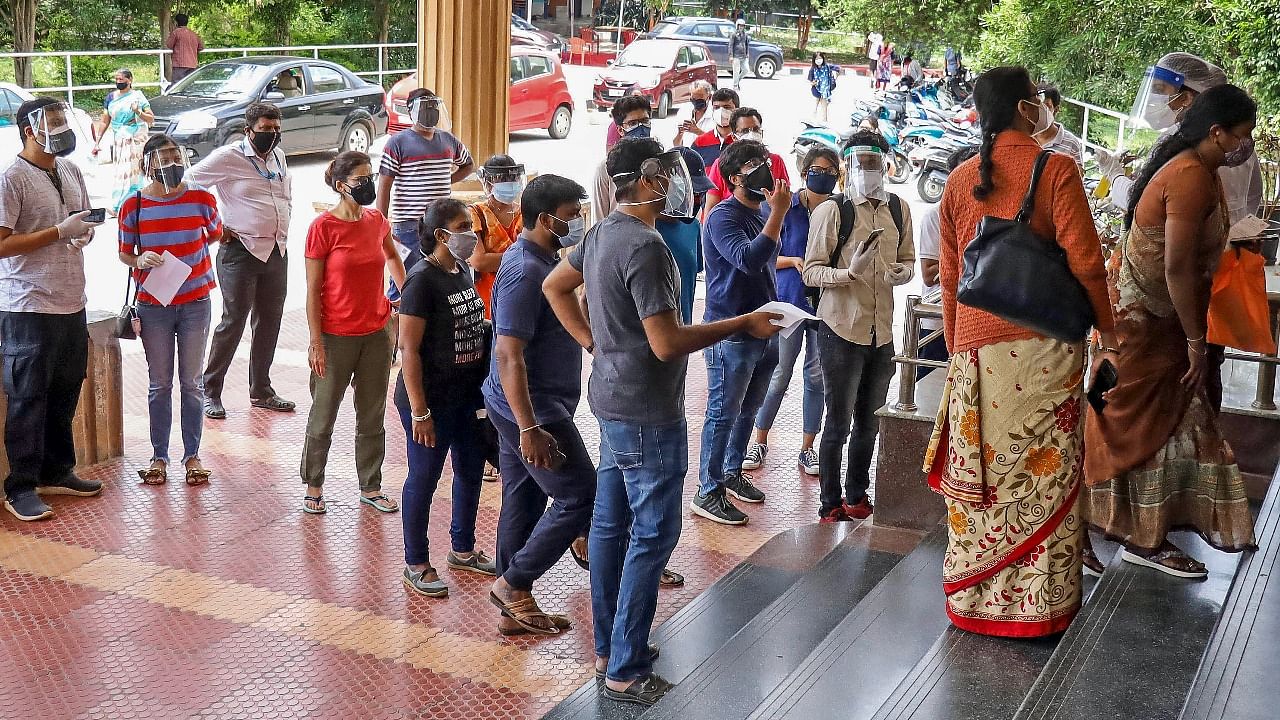 Beneficiaries stand in a queue to receive Covid-19 vaccine dose at CV Raman Hospital in Bengaluru. Credit: PTI Photo