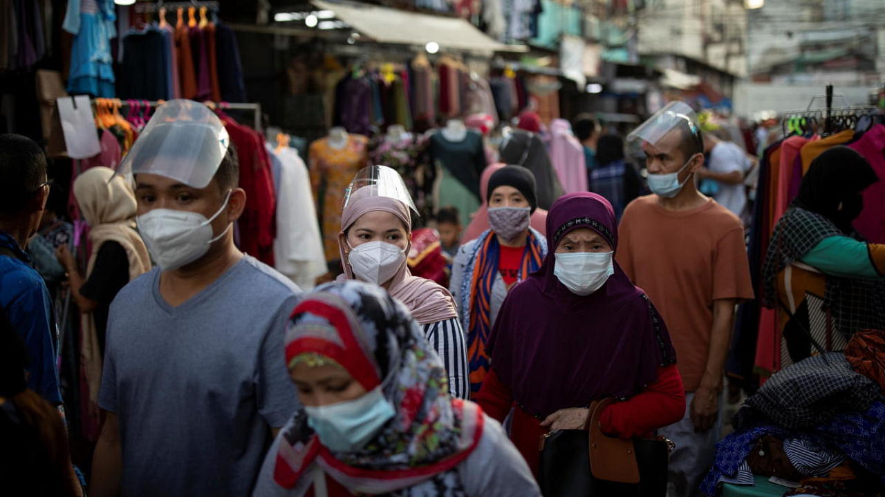 Filipino Muslims shop at a street market ahead of the Eid al-Fitr festival marking the end of the Islamic holy month of Ramadan, amid the coronavirus disease outbreak in Quiapo, Manila, Philippines. Credit: Reuters Photo
