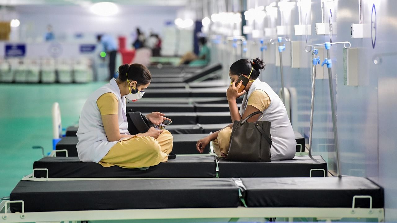 Health workers wait for their duty schedule, at the 500 ICU beds service for Covid-19 patients at Ramlila Maidan opposite GTB hospital in New Delhi, Tuesday, May, 11, 2021. Credit: PTI Photo