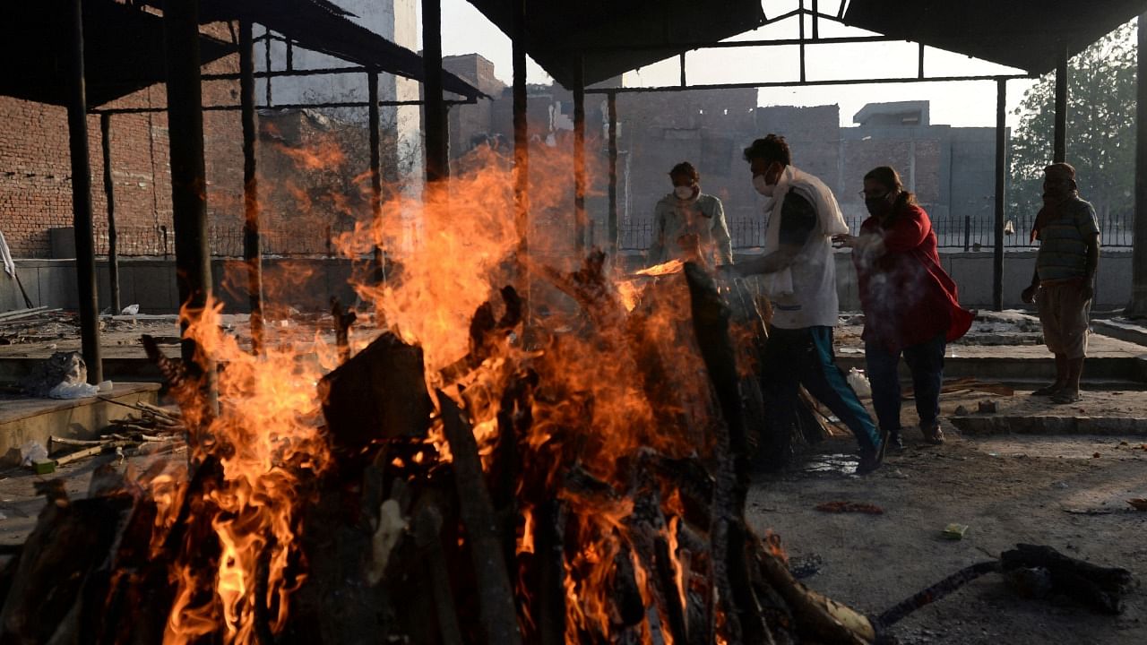 Harrowing images from overwhelmed crematoriums, graveyards, and even makeshift funeral pyres have highlighted the scale of the crisis. Credit: AFP Photo