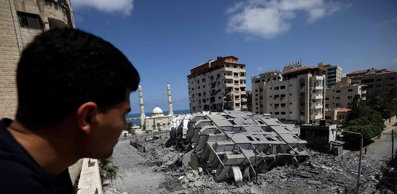 A Palestinian man looks at a destroyed building in Gaza City. Credit: AFP Photo